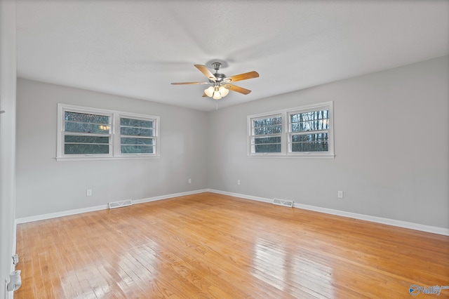 empty room with light hardwood / wood-style floors and ceiling fan