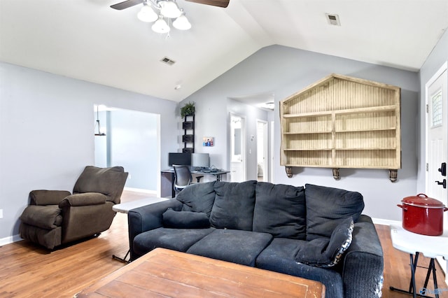 living room with hardwood / wood-style flooring, ceiling fan, and lofted ceiling