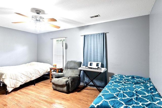 bedroom with ceiling fan and hardwood / wood-style floors