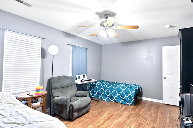 bedroom with hardwood / wood-style flooring and ceiling fan