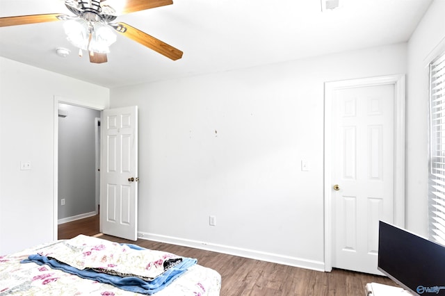 bedroom featuring ceiling fan and dark wood-type flooring