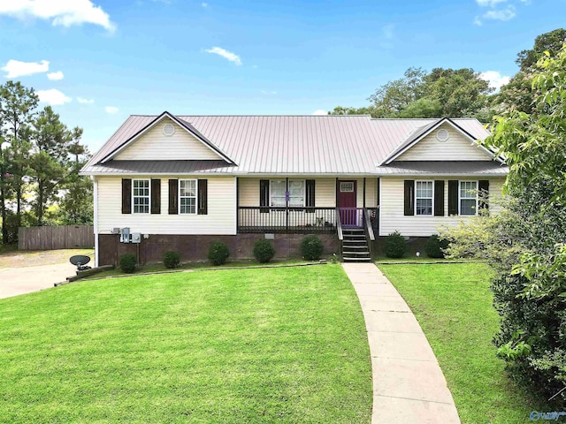 single story home featuring covered porch and a front lawn