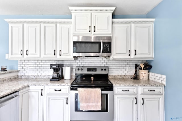 kitchen with decorative backsplash, white cabinetry, and stainless steel appliances