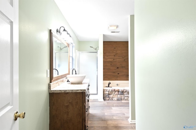 bathroom featuring vanity, separate shower and tub, and wood-type flooring