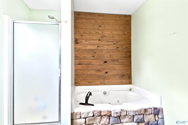 bathroom featuring shower with separate bathtub