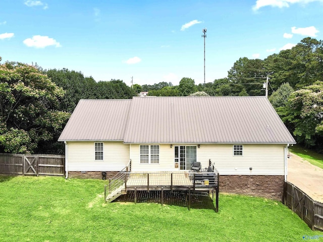 back of house featuring a lawn and a wooden deck