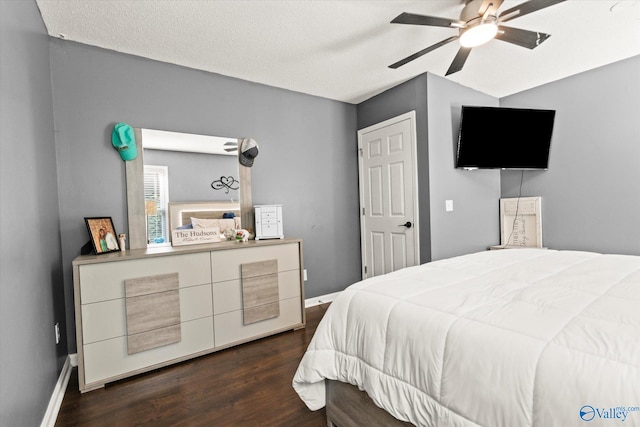 bedroom featuring ceiling fan, dark hardwood / wood-style flooring, and a textured ceiling