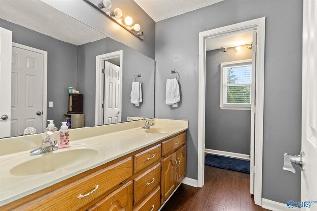 bathroom featuring hardwood / wood-style floors, a textured ceiling, and vanity