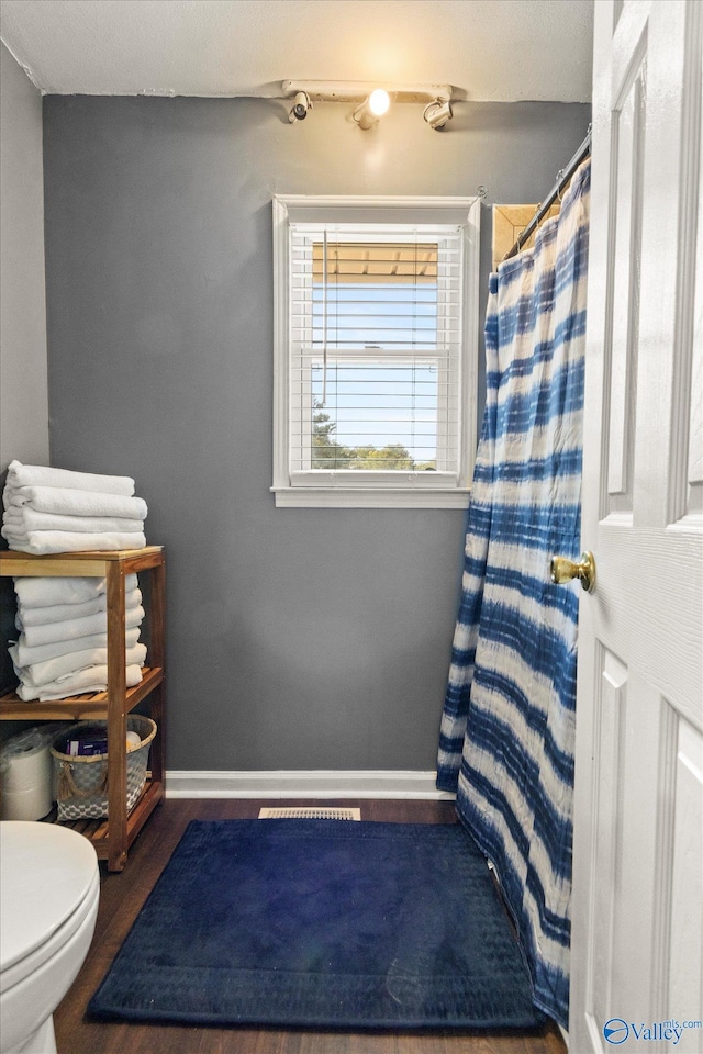 bathroom featuring toilet and hardwood / wood-style floors