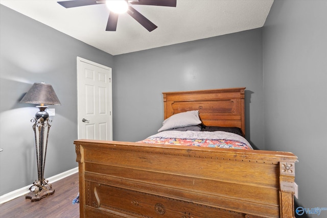 bedroom featuring dark wood-type flooring and ceiling fan