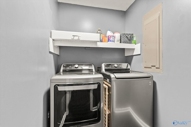 washroom featuring washing machine and dryer and electric panel