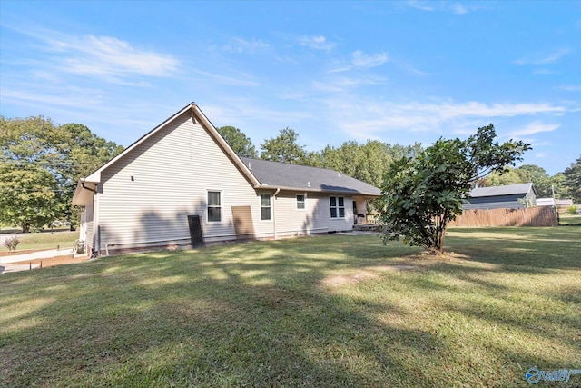 back of property featuring a lawn