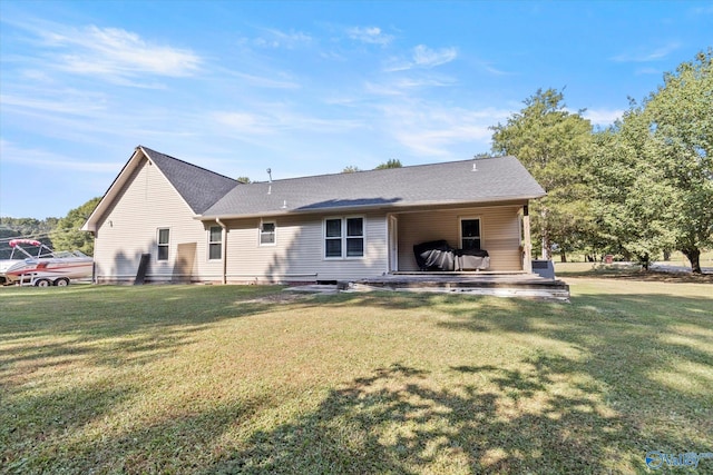 back of property featuring a lawn