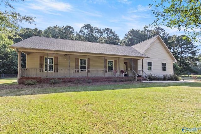 ranch-style home with a front yard and covered porch