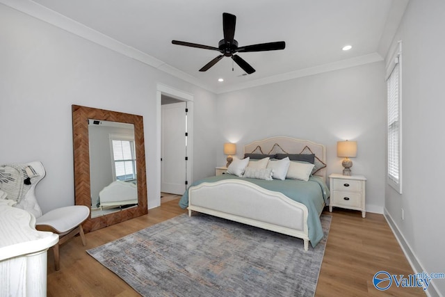 bedroom with ceiling fan, hardwood / wood-style flooring, and crown molding