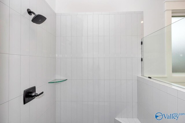 bathroom with a tile shower