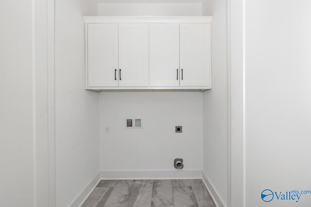 laundry area featuring electric dryer hookup, cabinets, hookup for a washing machine, and light tile patterned floors