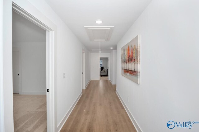 hallway with light colored carpet