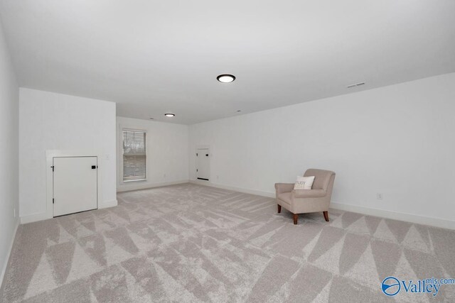 unfurnished room featuring light carpet