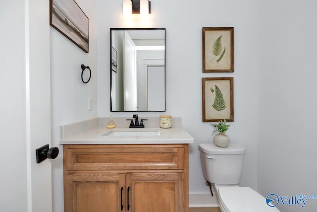 bathroom featuring toilet and vanity