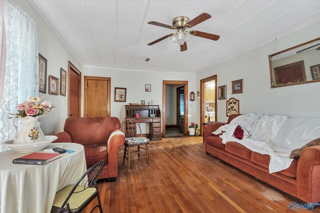 living room with ceiling fan and hardwood / wood-style floors