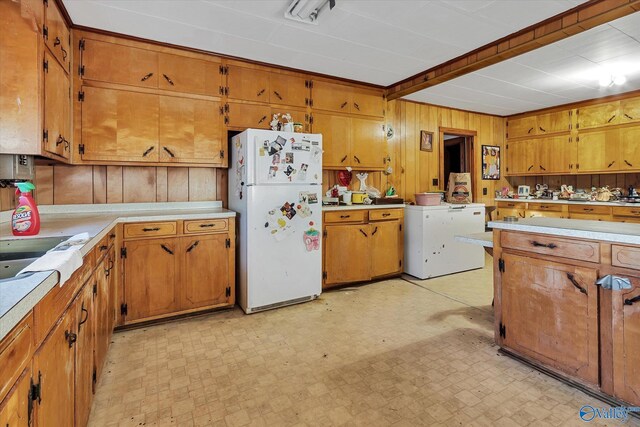 kitchen with wood walls, white fridge, and light tile patterned flooring