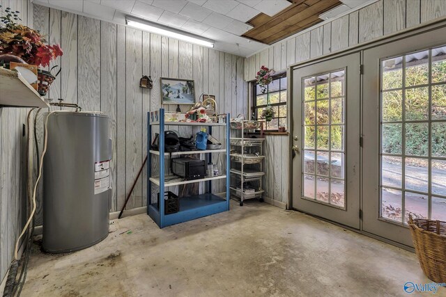 interior space with wooden walls and water heater