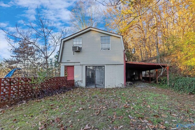 back of property featuring a carport