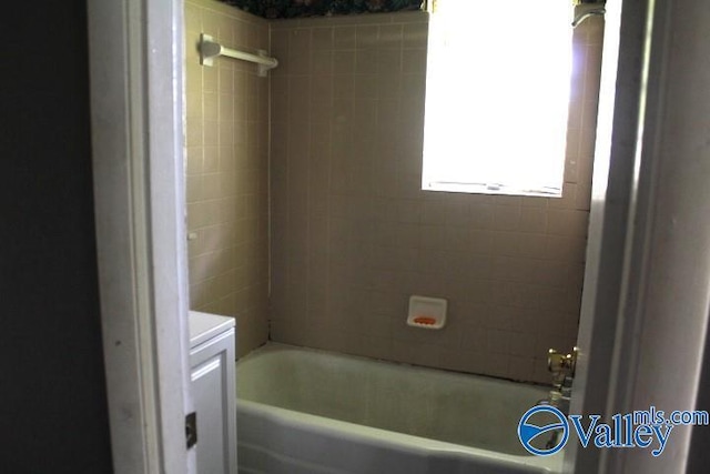 bathroom featuring bathing tub / shower combination and vanity