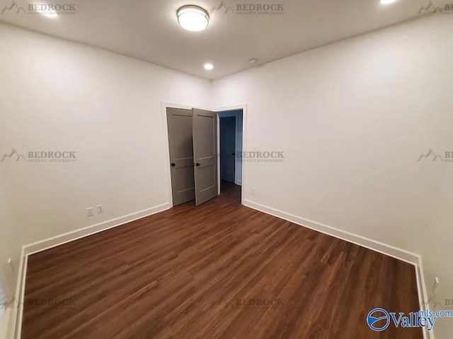 unfurnished bedroom with dark hardwood / wood-style floors