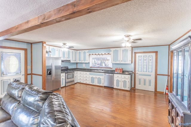 kitchen featuring sink, white cabinetry, light hardwood / wood-style flooring, and stainless steel appliances