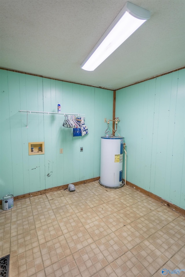 basement with light tile patterned flooring and electric water heater