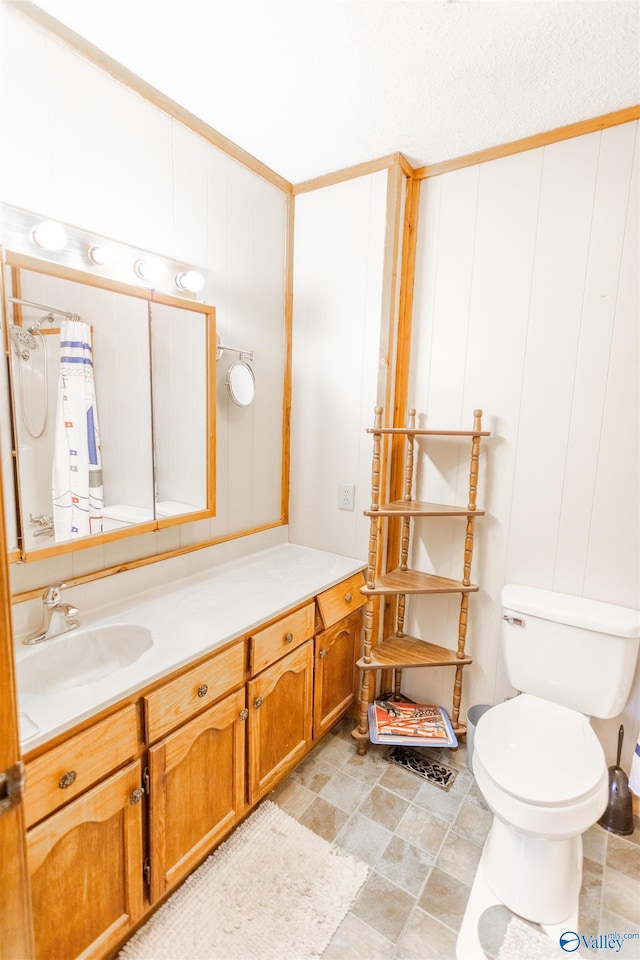 bathroom with vanity, tile patterned floors, a textured ceiling, and toilet