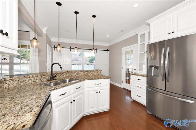 kitchen with appliances with stainless steel finishes, sink, stone counters, dark hardwood / wood-style floors, and white cabinetry