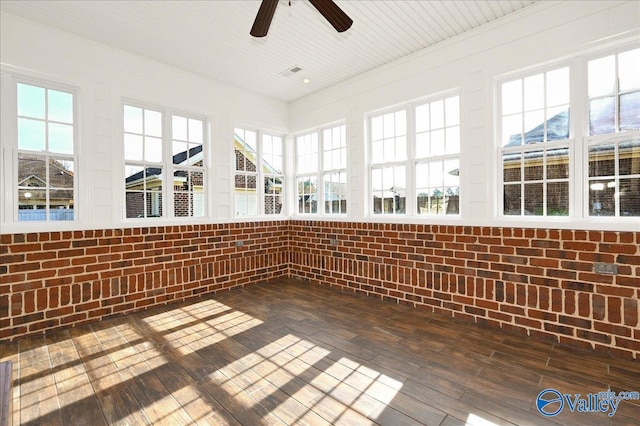 unfurnished sunroom with ceiling fan