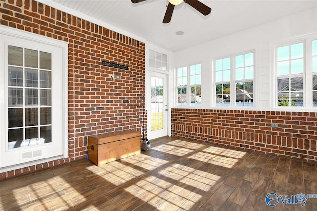 unfurnished sunroom featuring ceiling fan