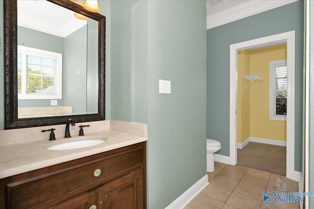 bathroom with tile patterned floors, vanity, ornamental molding, and toilet