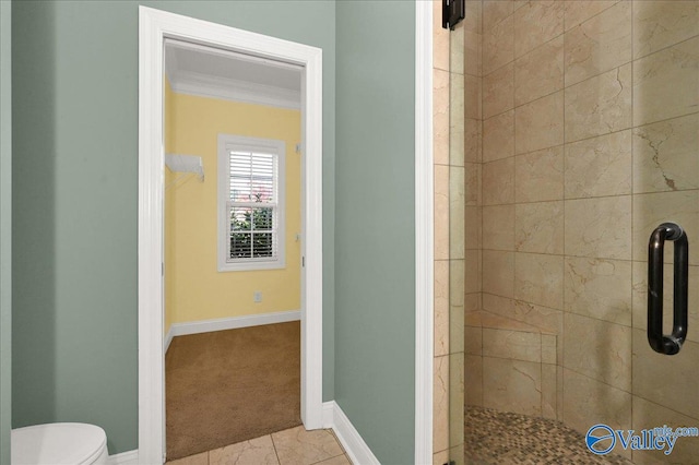 bathroom with crown molding, tile patterned flooring, a shower with shower door, and toilet