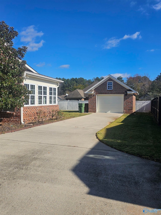 view of side of property with a lawn and a garage