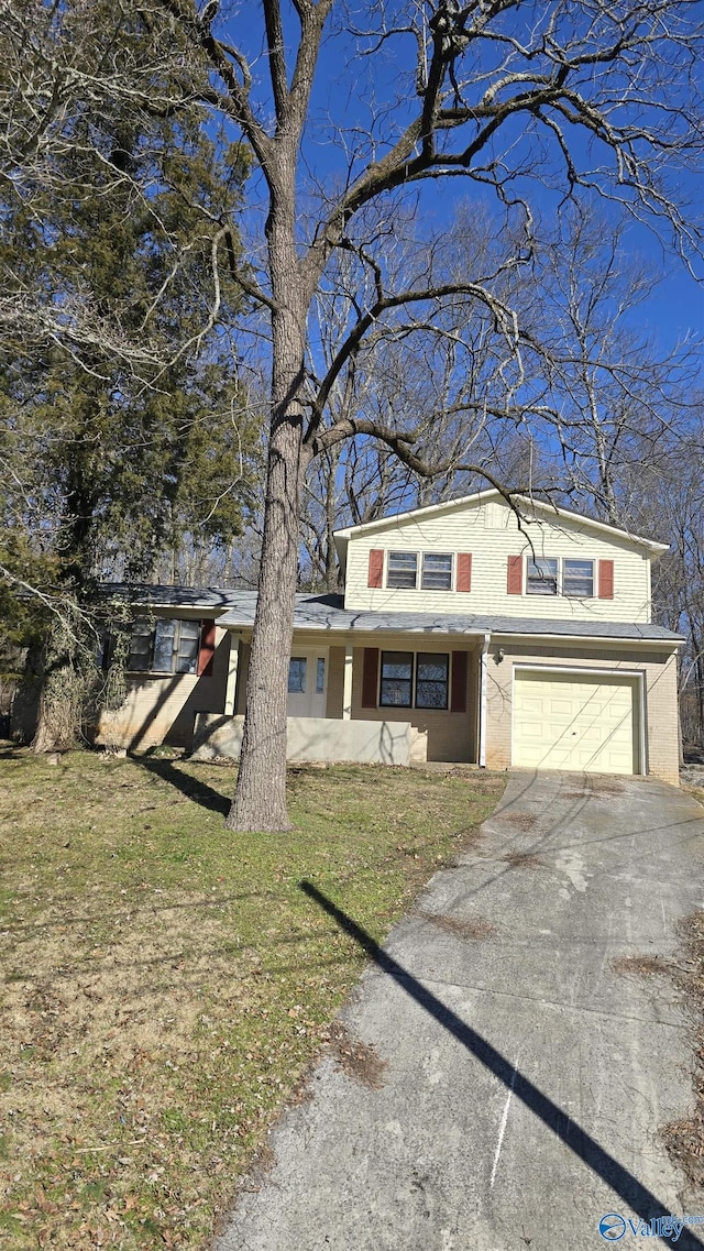 front facade featuring a garage and a front lawn