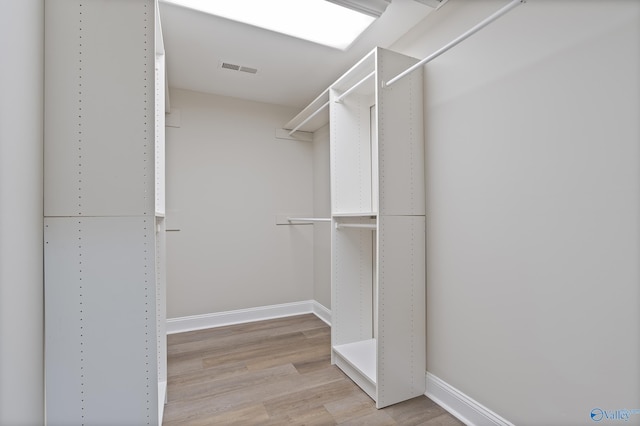 spacious closet featuring light wood-style floors and visible vents