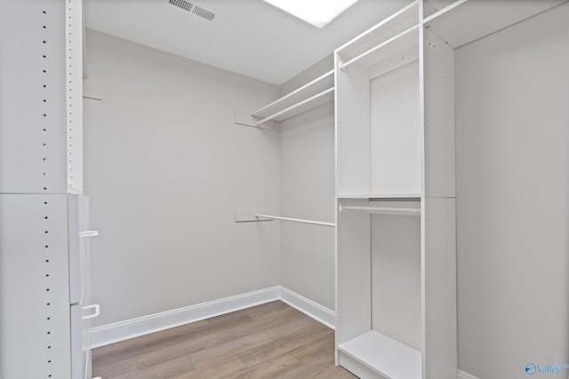 walk in closet with visible vents and light wood-type flooring