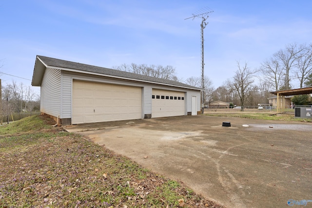 detached garage featuring cooling unit