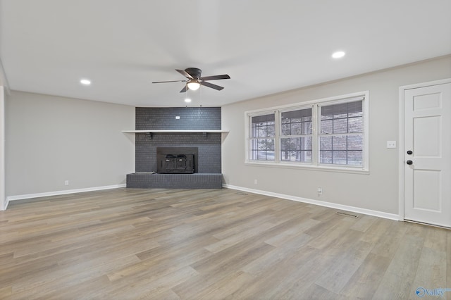 unfurnished living room with recessed lighting, light wood-type flooring, and baseboards