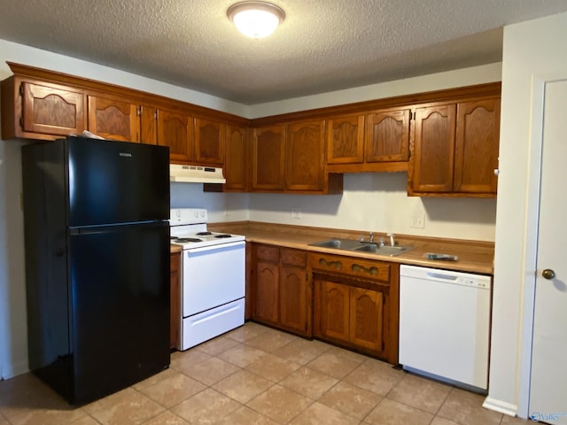 kitchen with sink, white appliances, and a textured ceiling