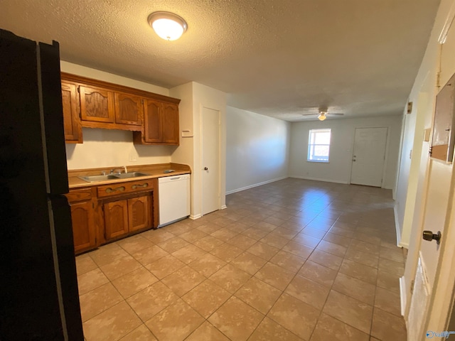 kitchen featuring a textured ceiling, dishwasher, black refrigerator, sink, and ceiling fan