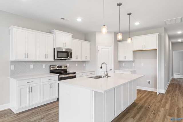 kitchen featuring white cabinets, tasteful backsplash, dark wood-type flooring, and stainless steel appliances