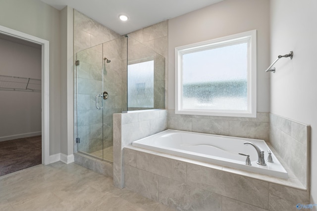 bathroom featuring tile patterned floors and separate shower and tub