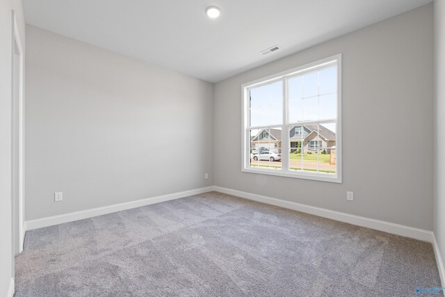 unfurnished room featuring light carpet