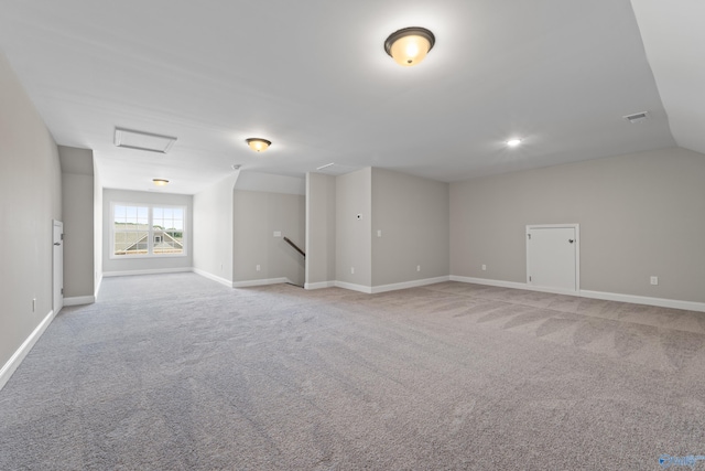 additional living space with light carpet and lofted ceiling